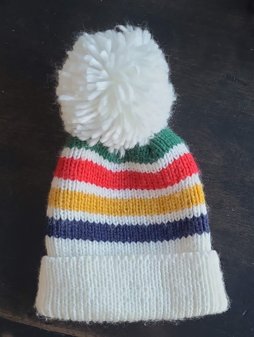 The BAY Stripes White Pom Hat with Red, Yellow, Green & Navy Colours
